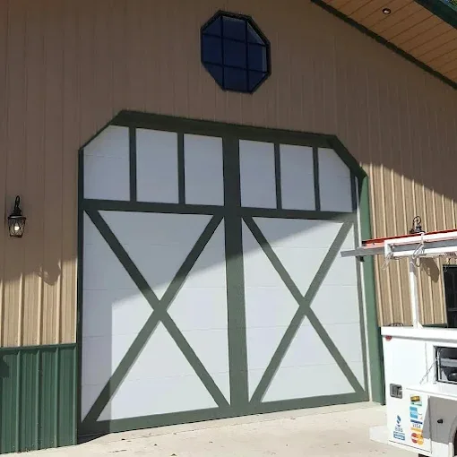Custom barn-style crossbuck garage door on building by Affordable Door Co Oklahoma City