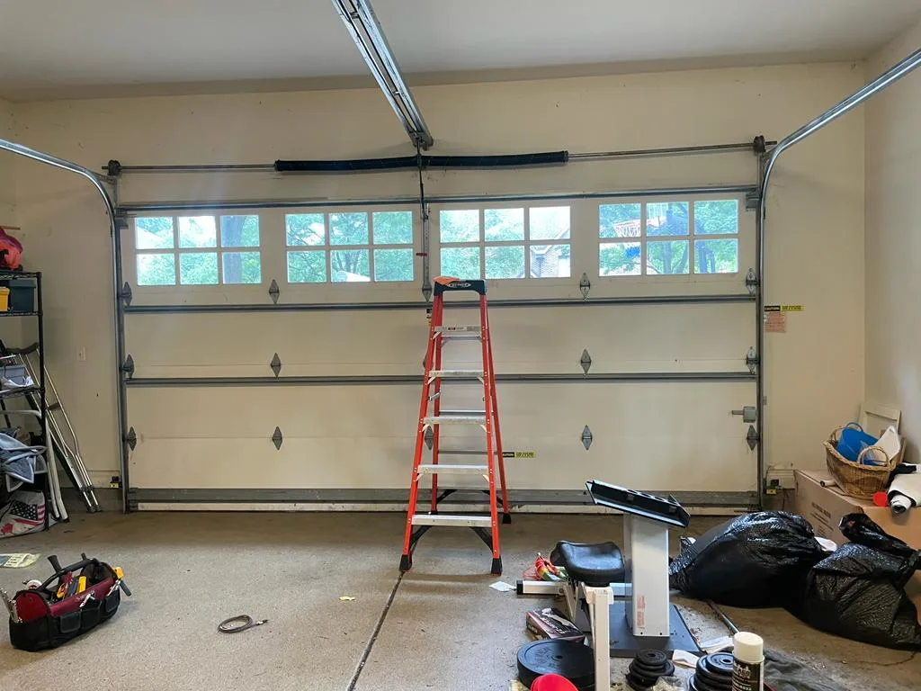 Garage door spring and track repair in progress by Affordable Door Co Oklahoma City